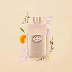 Gucci Guilty next to a ruler to show 90ml scale and travel-friendly benefit