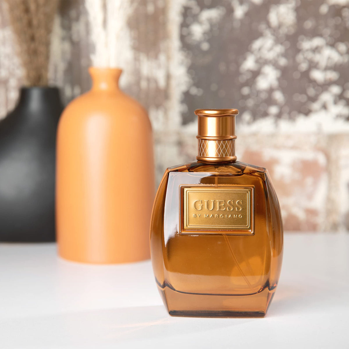 GUESS Marciano spray action from bottle, demonstrating easy application and control