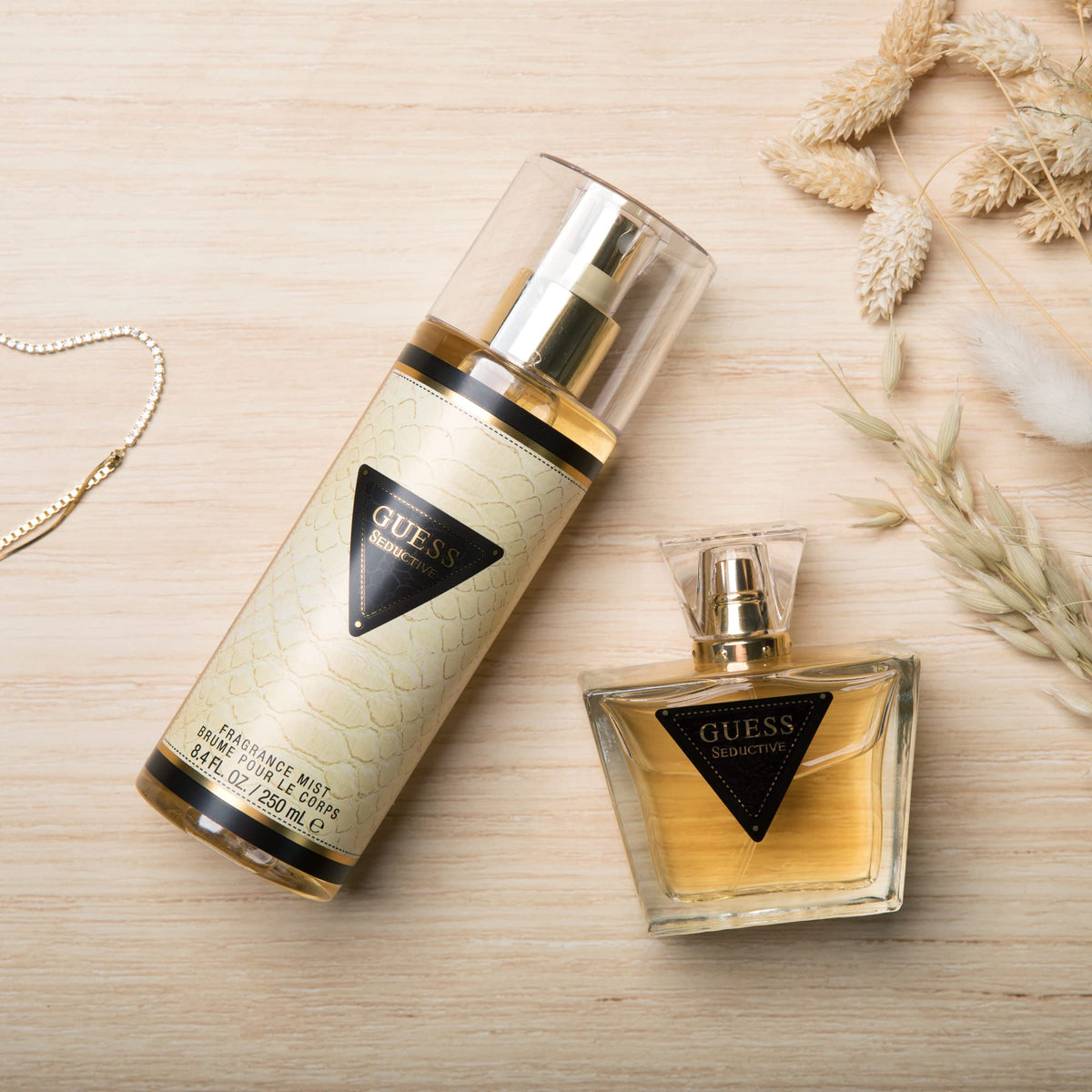 Guess bottle spraying fine mist to create subtle, alluring scent