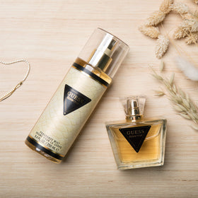 Guess bottle spraying fine mist to create subtle, alluring scent