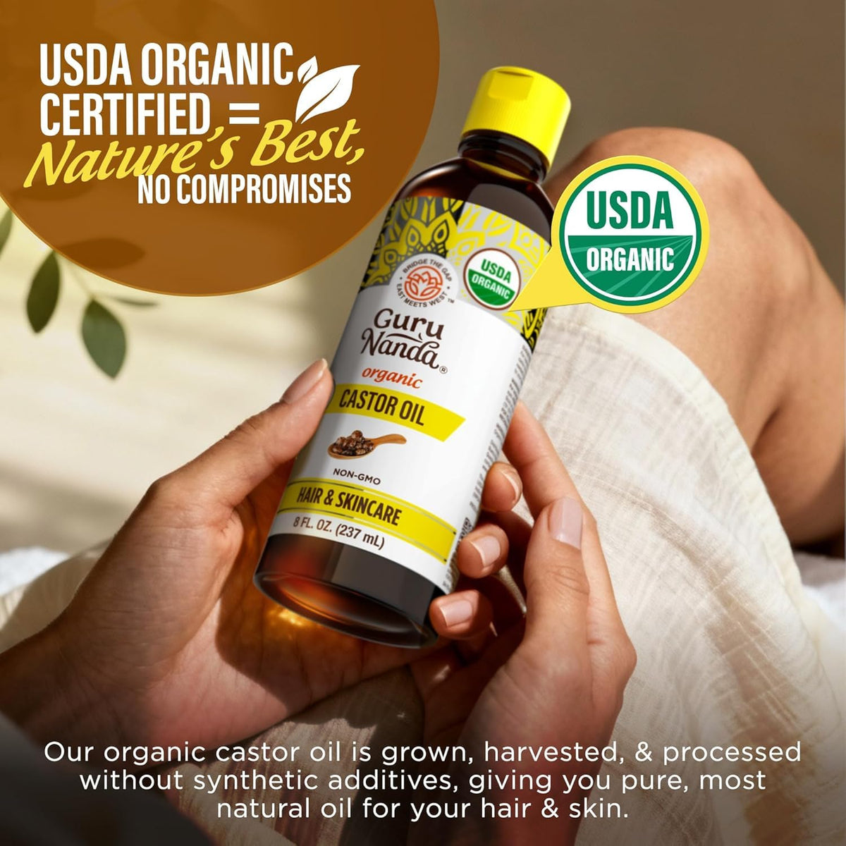 Drop of GuruNanda castor oil texture on fingertip demonstrating rich hydration