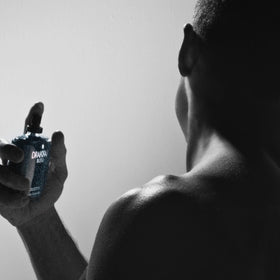 Guy Laroche Drakkar Bleu next to a coin for scale to show 3.4 fl oz portability benefit