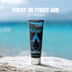 H2Ocean 2.5 oz tube next to hand for scale highlighting portable aftercare convenience