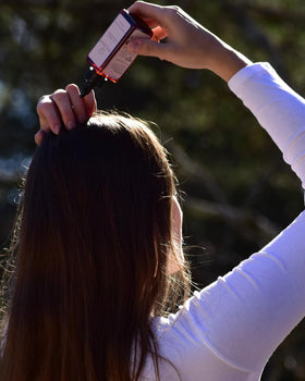 Hair Dance bottle inside a purse demonstrating travel-friendly convenience