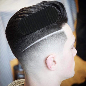 HAIR GRIPPERS in use on a client at a barber station keeping hair neatly sectioned