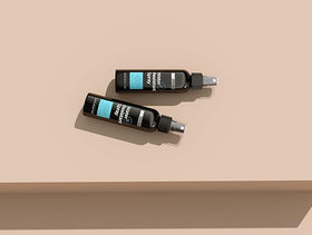 Hair Illusion pack of two beside a hand showing size and convenient travel benefit