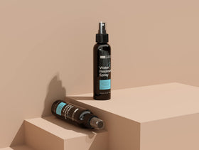 Hair Illusion bottle beside hand to show compact travel-friendly size