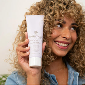 Hairitage lifestyle shot of curly-haired person using products showing practical routine benefits