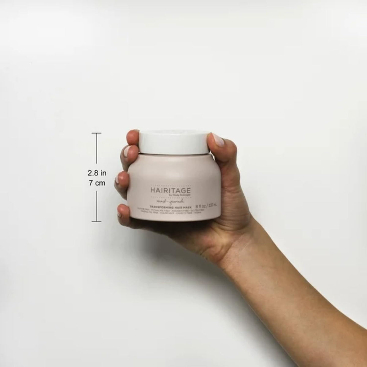 Hairitage jar in hands for size comparison and easy at-home treatment