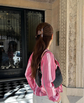 Hana Mia clipped to a desk edge in lifestyle scene for quick, on-the-go styling benefit