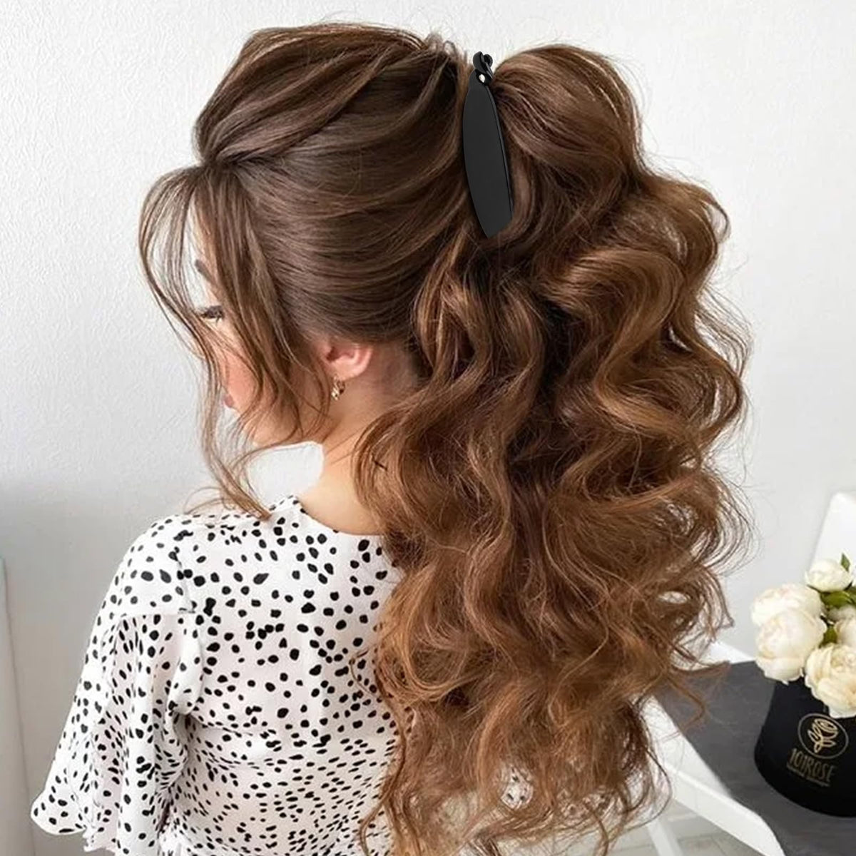 Hapdoo holding thick curly hair in a full bun for comfortable support