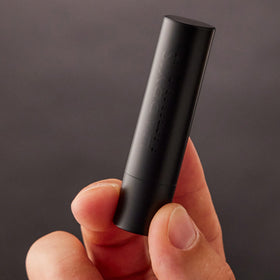 Harry's matte black packaging detail conveying premium minimalist design