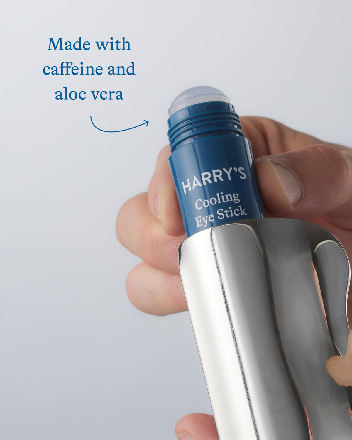 Harry's gua sha tool in hand for scale showing compact size and precise contouring benefit