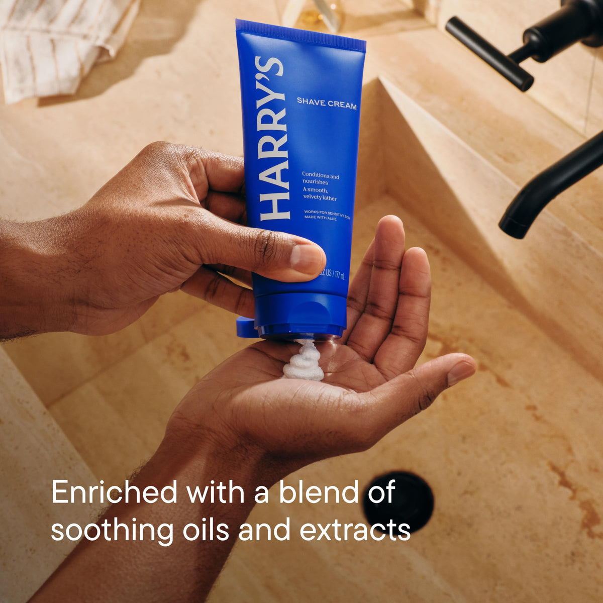 Hand holding Harry's 2 oz tube highlighting travel-ready convenience and control