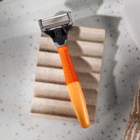 Harry's shaving kit packaging flatlay presenting handle and three refills neatly