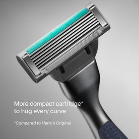 Harry's razor handle held in hand illustrating balanced weight and control