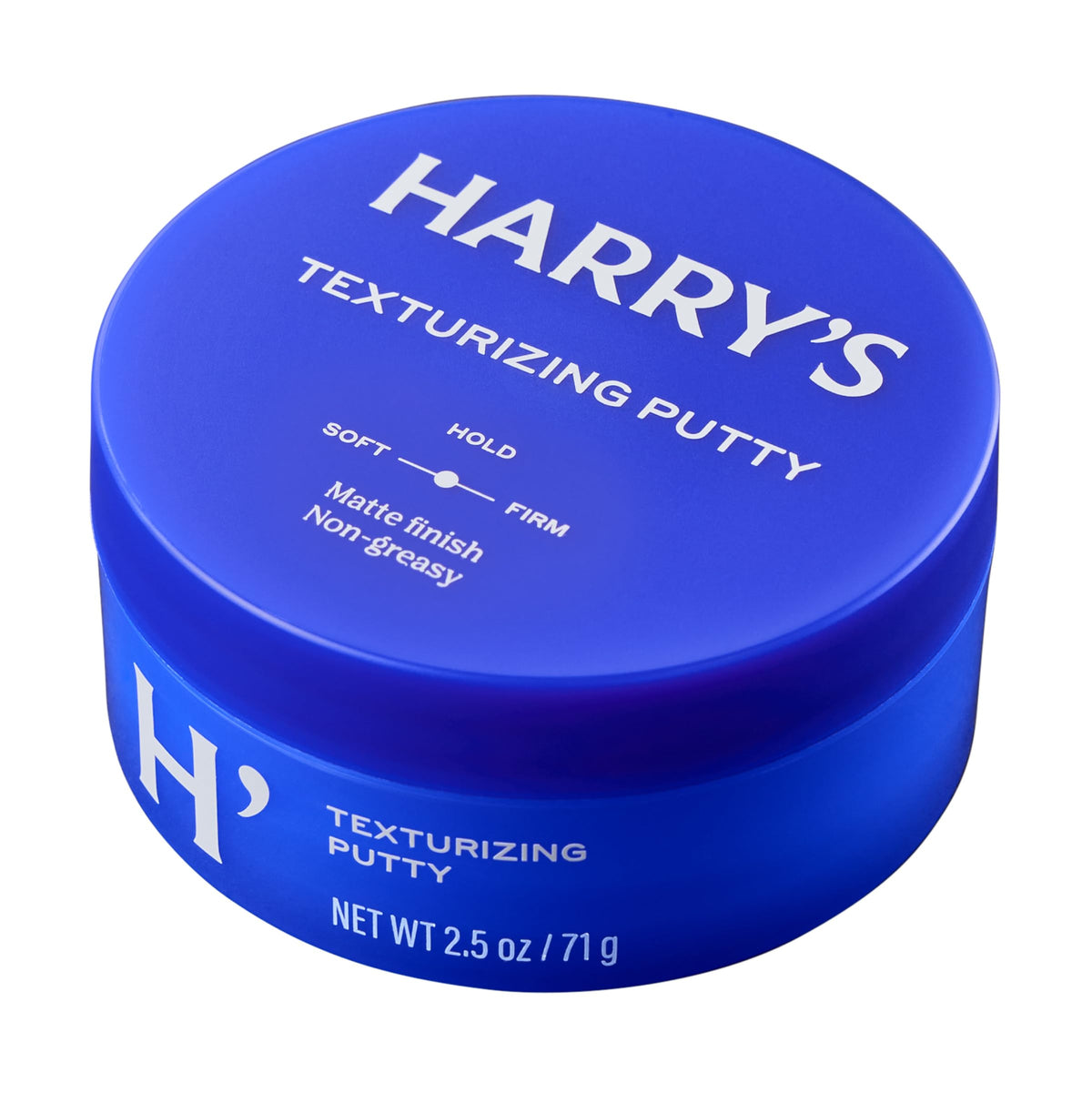 Harry's tub next to coin to show 2.5 oz size and portability