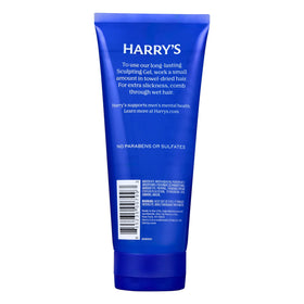 Harry's size comparison next to ruler to display 6.7 fl oz scale and portable dimensions