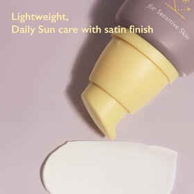 HARUHARU sunscreen held in hand to show compact 50ml travel-friendly size