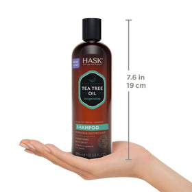 Applying HASK shampoo to wet hair to demonstrate scalp massage benefit
