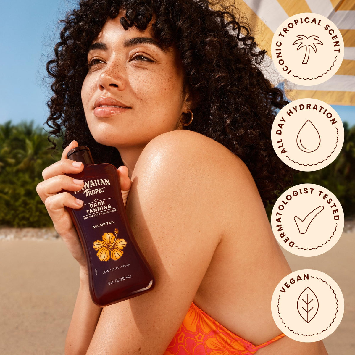 Hawaiian Tropic bottle on beach towel conveying outdoor use and scent appeal