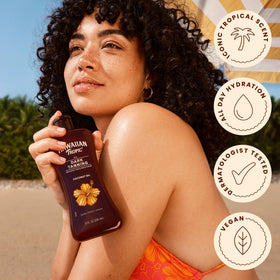 Hawaiian Tropic bottle on beach towel conveying outdoor use and scent appeal