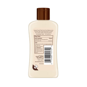 Hawaiian Tropic open bottle applying lotion on arm for quick absorbency benefit