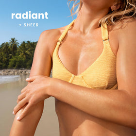 Hawaiian Tropic lotion texture close-up showing lightweight, non-greasy feel