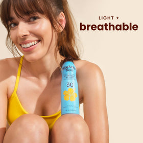 Hawaiian Tropic clear spray texture on skin closeup demonstrating non-greasy finish