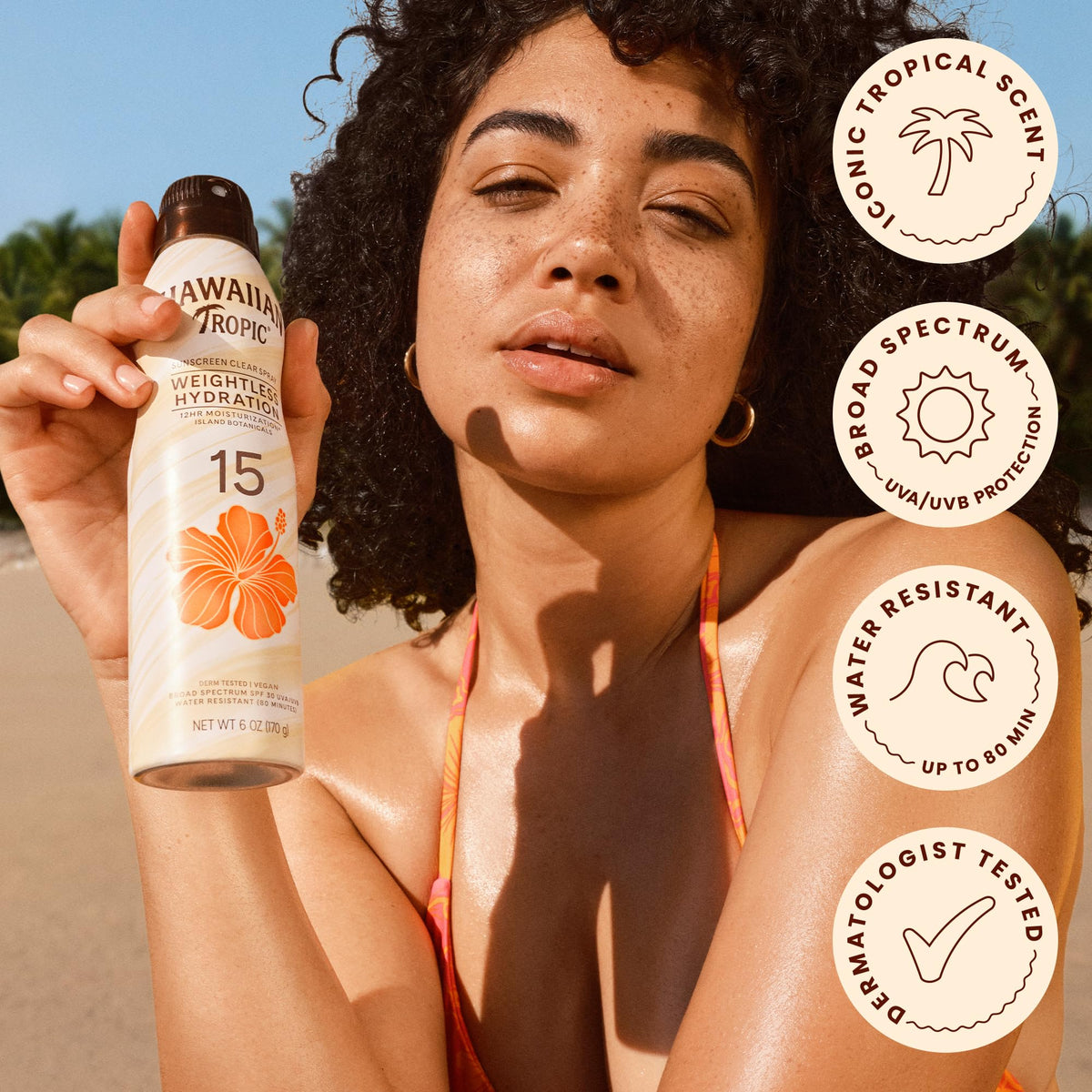Hawaiian Tropic clear spray texture on skin showing lightweight hydration