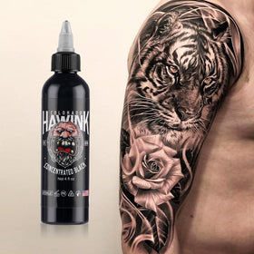 HAWINK bottle next to tattoo needle setup illustrating scale and ready-to-use volume