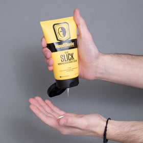 Hand applying HeadSlick with HeadBlade razor, shows improved razor control and comfort