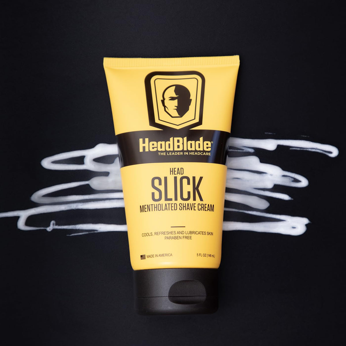 HeadSlick on bathroom shelf with other HeadBlade items, suggests complete scalp care system