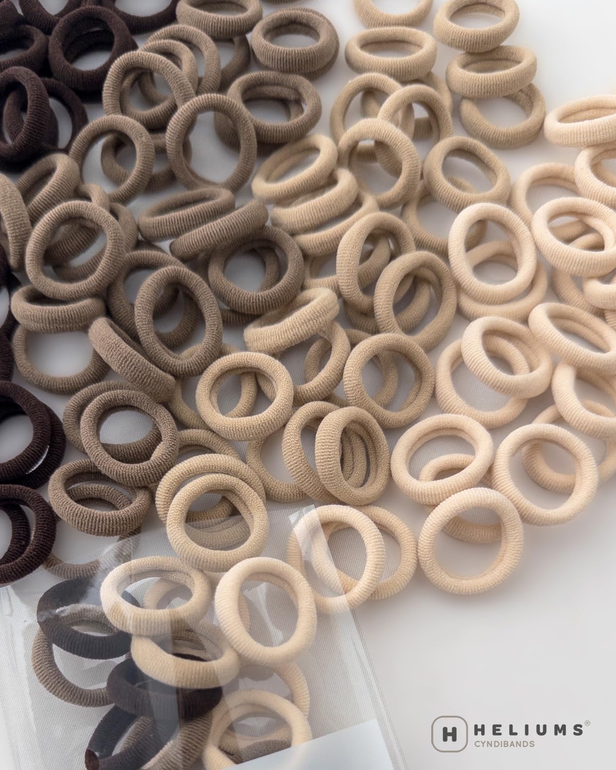 Side-by-side Heliums elastic versus rubber band emphasizing no-snag removal benefit
