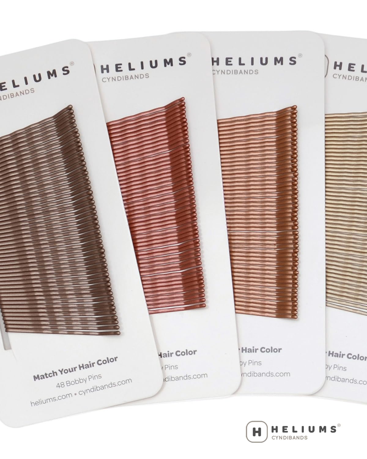 Heliums lifestyle flatlay with pins and blonde accessories for everyday use