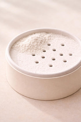 Herb & Root applying powder to underarm to reduce friction