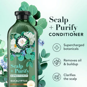 Herbal Essences nourishing spray in hand demonstrating lightweight application