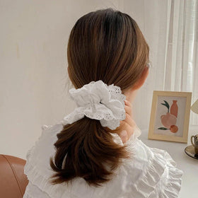 Heyiminy held in hand next to ruler to show 7-inch oversized scale