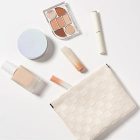 HIGH FIT pouch with lipstick and earbuds demonstrating multi-purpose organization