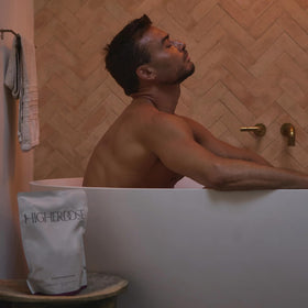 HigherDOSE soak staged in bathroom to inspire calm spa-at-home benefit