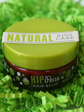 Hip Peas jar next to a key for scale showing compact travel-friendly size