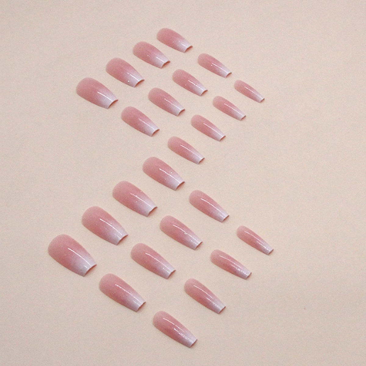 Hkanlre nails held in hand to show medium coffin length and natural scale for sizing