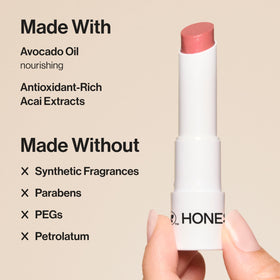 Honest Beauty balm applied on lips demonstrating hydrating, glossy finish