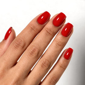 HOSAILY front packaging showing ruby red press-on nails and kit benefits