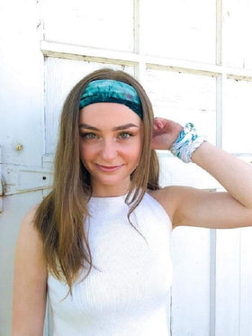 Huachi headband held in hand to show scale and stretchability