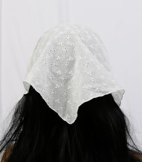 Huachi bandana next to hand showing size and easy-wear benefit
