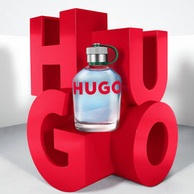 Hugo Boss HUGO Man bottle beside green apple and fir sprig to show scent notes