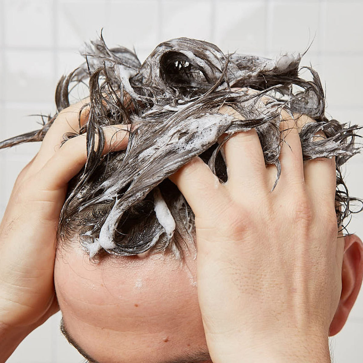 Huron shampoo on shower shelf in lifestyle setting promoting fresh routine