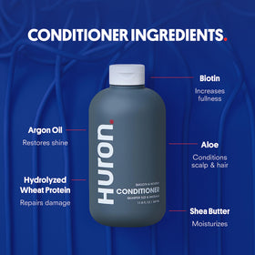Huron bottle held in hand to show 11.7 fl oz size for realistic scale