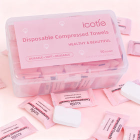 ICOTLE towel in hand for scale showing compact coin-to-cloth expansion benefit